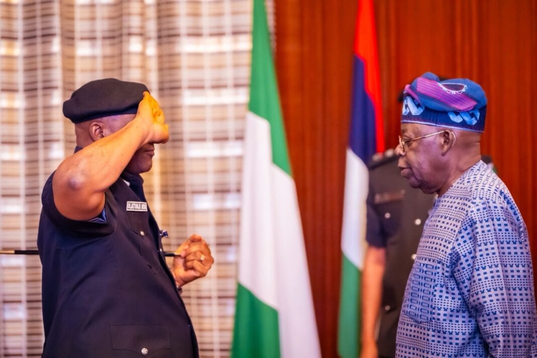 President Tinubu, right, Acting IGP Tunji Disu