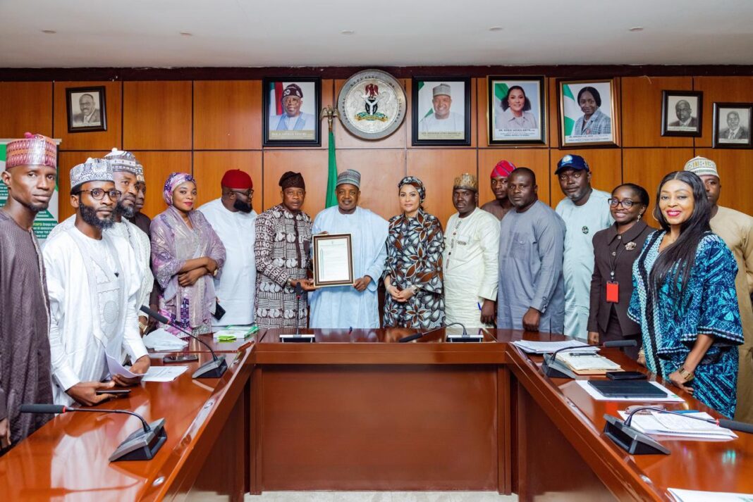 Senator Bagudu receiving the letter of his appointment as a patron