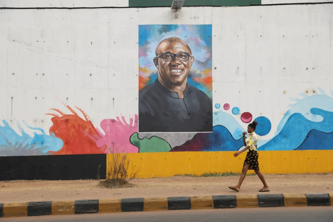 A woman walks past a graffiti depicting Labour Party presidential candidate, Peter Obi, ahead of Nigeria’s presidential election in Awka, Anambra state, Nigeria, on February 23, 2023. Temilade Adelaja/Reuters