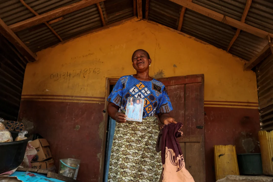 Aduke Balogun, whose daughter was among dozens of pupils and teachers abducted in a large-scale school attack in southwestern Nigeria, reacts while displaying her daughter’s photograph and clothing after an interview with Reuters at her home in Yawota, Oyo state, Nigeria, on June 2, 2026. Sodiq Adelakun/Reuters