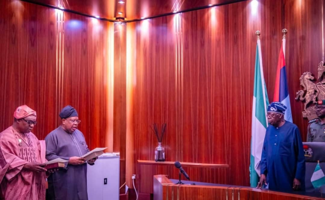 Mr Joseph Olasunkanmi Tegbe and Ambassador Sola Enikanolaiye taking their oath of office in the presence of President Bola Ahmed Tinubu
